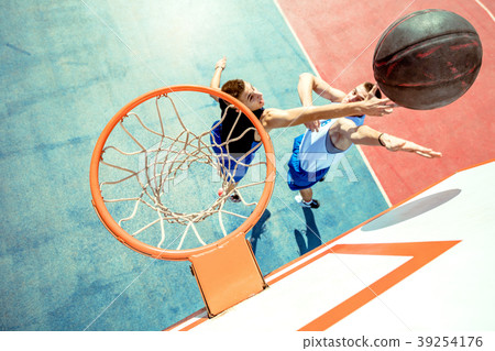 High angle view of basketball player dunking High angle view of basketball player dunking 39254176