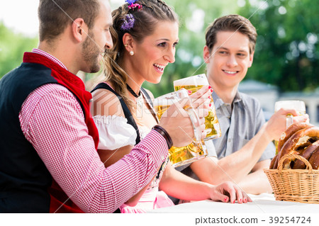 People with beer and pretzel in Bavaian inn 39254724