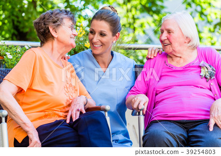 Geriatric nurse having chat with senior women Geriatric nurse having chat with senior women 39254803