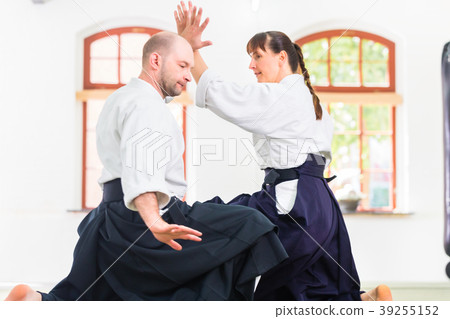 Man and woman fighting at Aikido martial arts 39255152