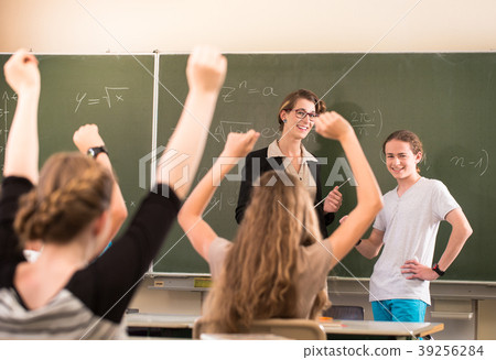 Math teacher standing in front of students who are 39256284
