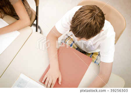 Student in school class learning or writing test Student in school class learning or writing test 39256303