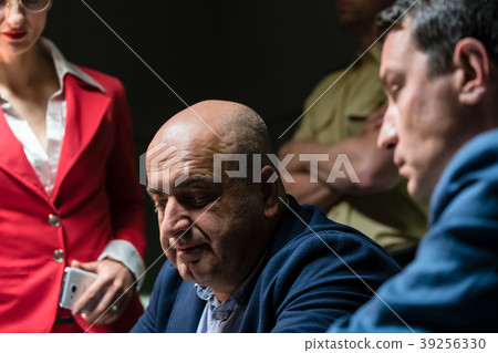 Middle-aged man calling his attorney for legal 39256330