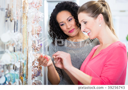 Two friends in jewelry department of shopping mall 39256743