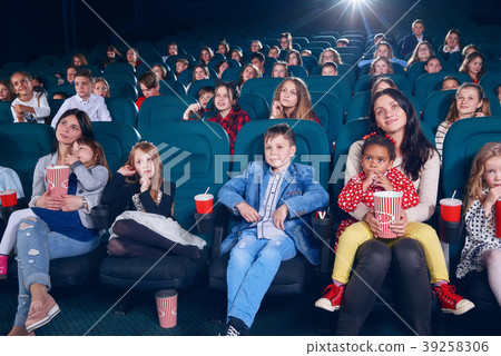 Mother watching movie with little children on Mother watching movie with little children on 39258306