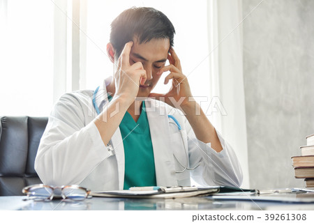 Stressed Young Asian male doctor is working. 39261308