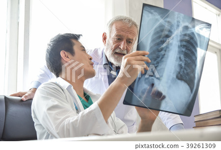 Senior Male and Young Asian man doctors are examining x-ray film 39261309