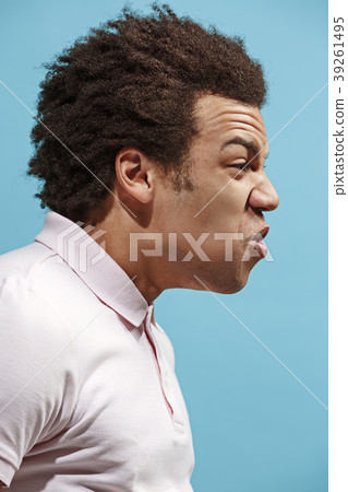 The young emotional angry man screaming on blue The young emotional angry man screaming on blue 39261495