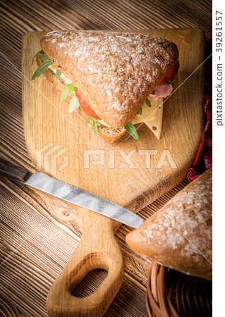 Triangular sandwich with cheese, ham and tomato. 39261557