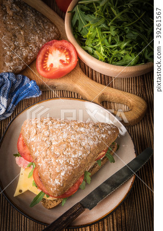 Triangular sandwich with cheese, ham and tomato. Triangular sandwich with cheese, ham and tomato. 39261567