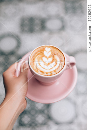 Hand with cappuccino cup Hand with cappuccino cup 39262691