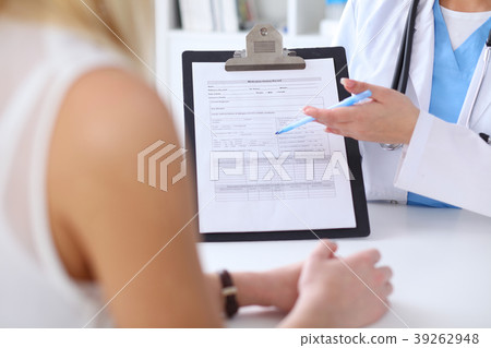 Close up of a doctor and patient hands whil Close up of a doctor and patient hands whil 39262948