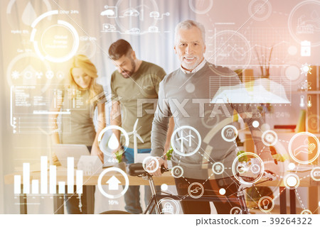 Happy mature man smiling and standing with his 39264322