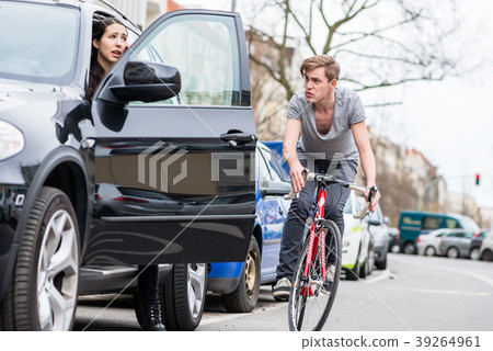 Young bicyclist shouting while swerving for Young bicyclist shouting while swerving for 39264961