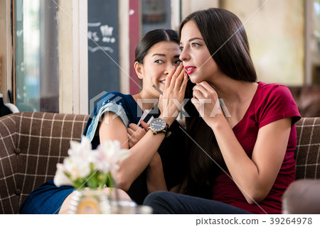 Young woman sharing secrets with her best friend 39264978