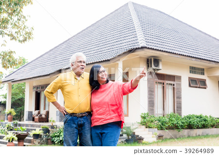 Happy elderly couple showing thumbs up in front of 39264989