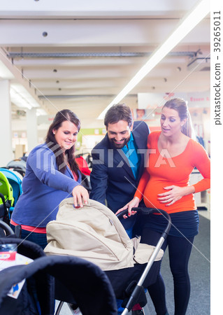 Woman, man, and sales lady in baby store Woman, man, and sales lady in baby store 39265011