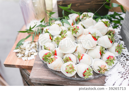 Strawberries covered in white chocolate on a 39265713