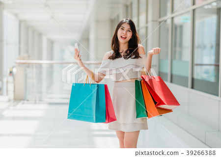 Asian woman enjoy shopping in mall Asian woman enjoy shopping in mall 39266388