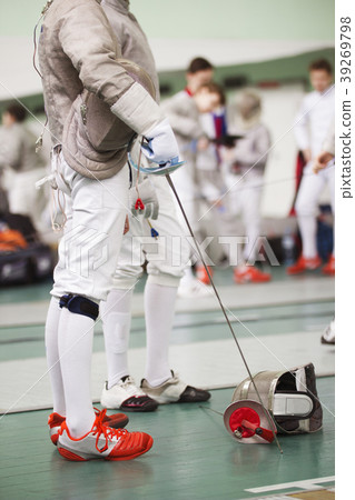 Fencer in white costume with rapier and protective Fencer in white costume with rapier and protective 39269798