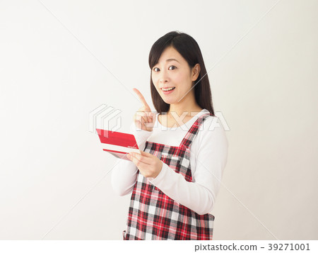 Laughing woman looking at a passbook Laughing woman looking at a passbook 39271001