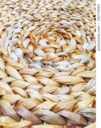 Close up photo of surface made of woven straw.  39274664