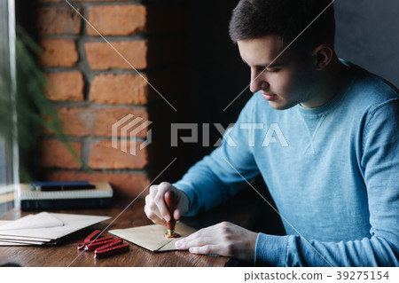 Man makes the stamp using sealing wax on the Man makes the stamp using sealing wax on the 39275154