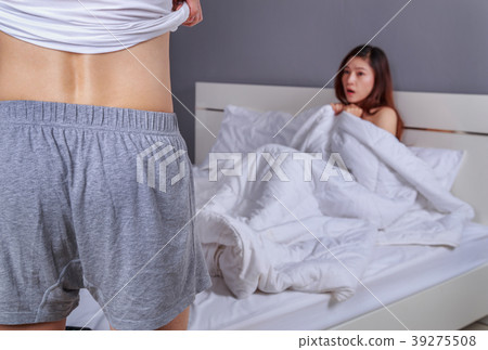 couple in bedroom is having sex, man taking his clothes off with 39275508