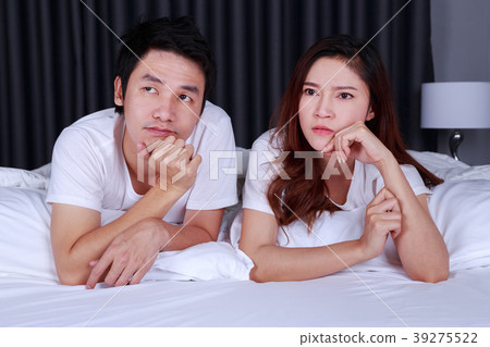young depressed couple on bed in bedroom 39275522