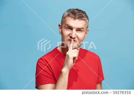 The young man whispering a secret behind her hand 39276358