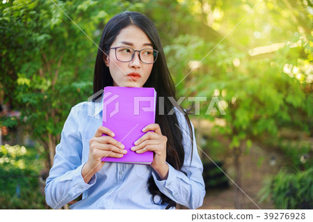 portrait woman with a book in garden portrait woman with a book in garden 39276928