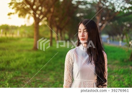 portrait of beautiful woman in park 39276961