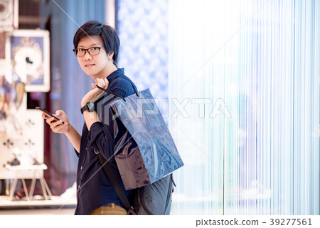 Asian man holding shopping bag in department store 39277561