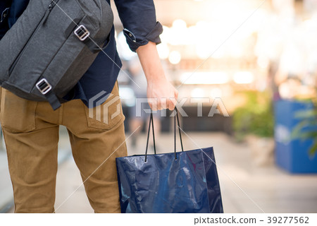 male hand holding shopping bag in department store 39277562