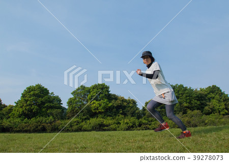 A woman jogging in fresh green 39278073