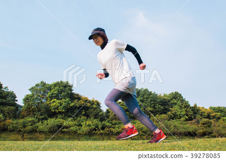 A woman jogging in fresh green 39278085