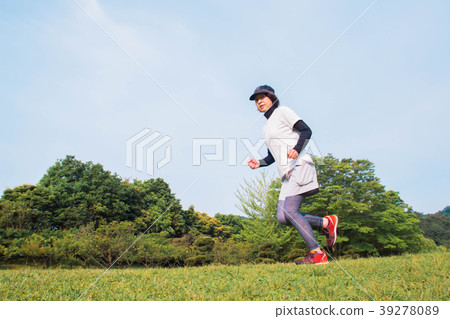 A woman jogging in fresh green 39278089