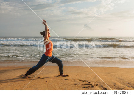 Woman doing yoga asana Virabhadrasana 1 Warrior Woman doing yoga asana Virabhadrasana 1 Warrior 39278851