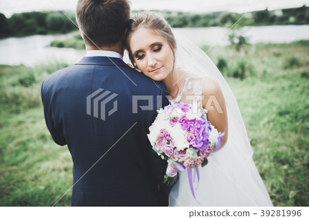 Perfect couple bride, groom posing and kissing in Perfect couple bride, groom posing and kissing in 39281996