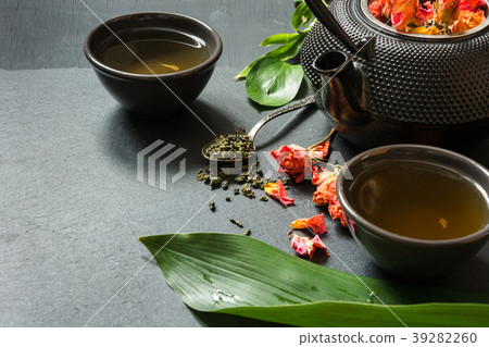 Green tea with rose flower on slate background. 39282260