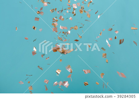 Golden confetti on pink background 39284305