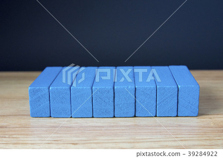 Wooden cubes on table over cement wall background Wooden cubes on table over cement wall background 39284922