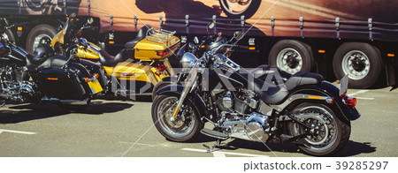 motorcycles stand in the parking lot waiting  39285297