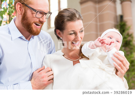 Parents with baby at christening in church 39286019