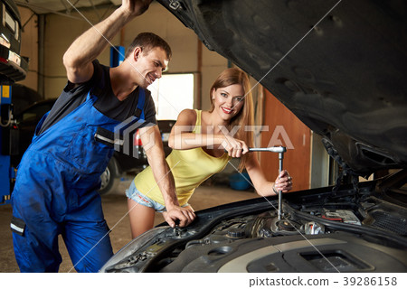 Girl repairing the car with a wrench 39286158