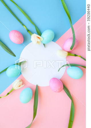 Easter eggs and spring flowers narcissi on blue ba Easter eggs and spring flowers narcissi on blue ba 39286440