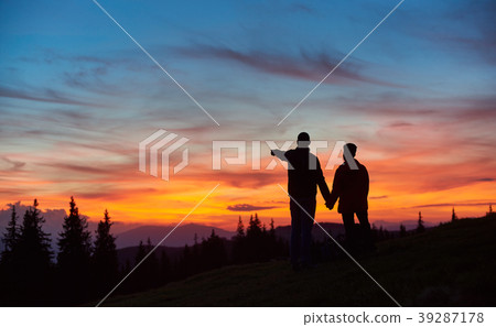 Couple hiking in the mountains together Couple hiking in the mountains together 39287178