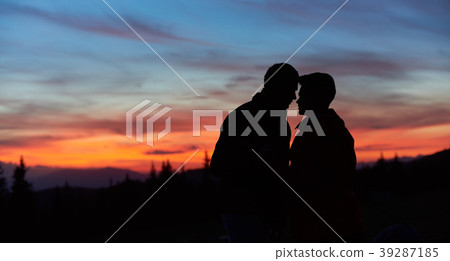 Couple hiking in the mountains together Couple hiking in the mountains together 39287185