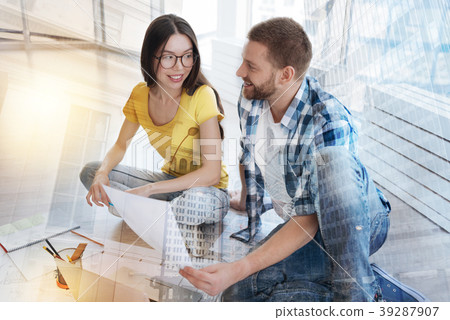 Relaxed worker looking at his pretty colleague Relaxed worker looking at his pretty colleague 39287907