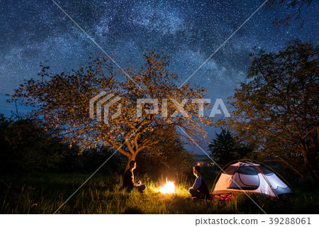 Tourists at campfire near tent. Night camping Tourists at campfire near tent. Night camping 39288061